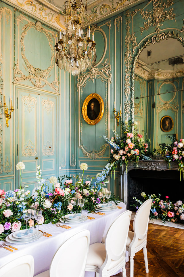 Blumig dekorierter Festsaal einer französischen Hochzeit.